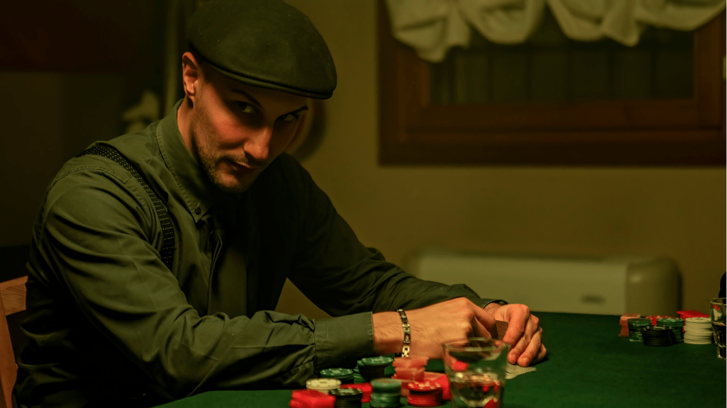 Man holding playing cards and casino chips